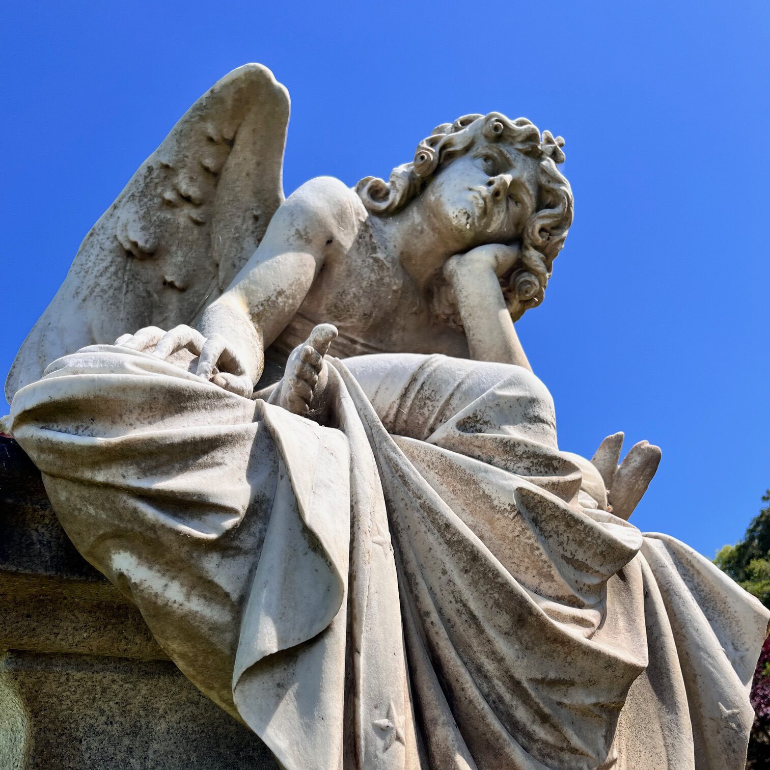 A bored looking angel sculpture from a cemetery
